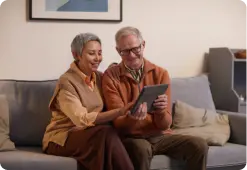 Elder couple looking at their tablet
